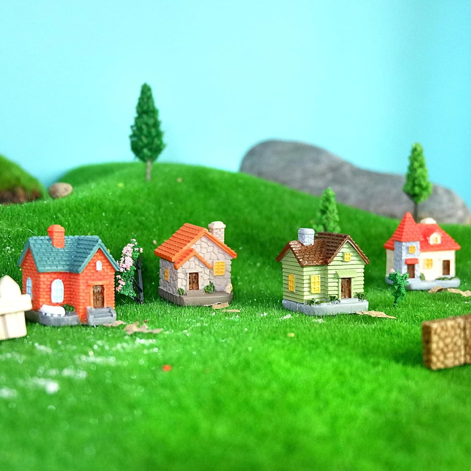 Miniature cottage houses on a grass diorama
